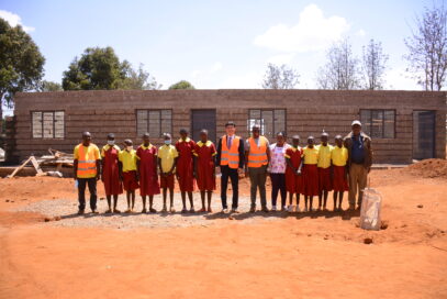 LG Electronics East Africa Managing Director Kim Sa-nyoung with HFH managers and students at the Mbombo Primary School construction site