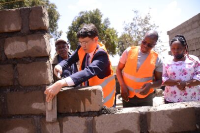 LG Electronics East Africa Managing Director Kim Sa-nyoung laying a stone during the construction at Mbombo Primary School