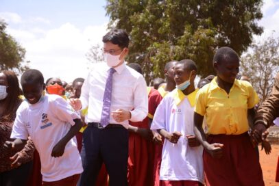 A photo of LG Electronics East Africa Managing Director Kim Sa-nyoung with students from Mbombo Primary School