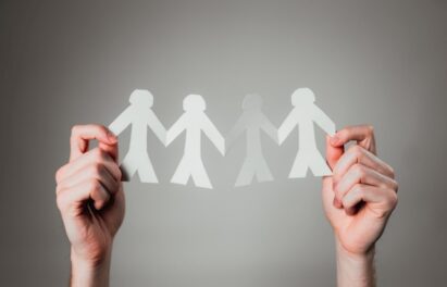 A person holding a paper chain family