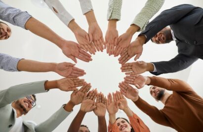 A group of people putting their hands together showing unity