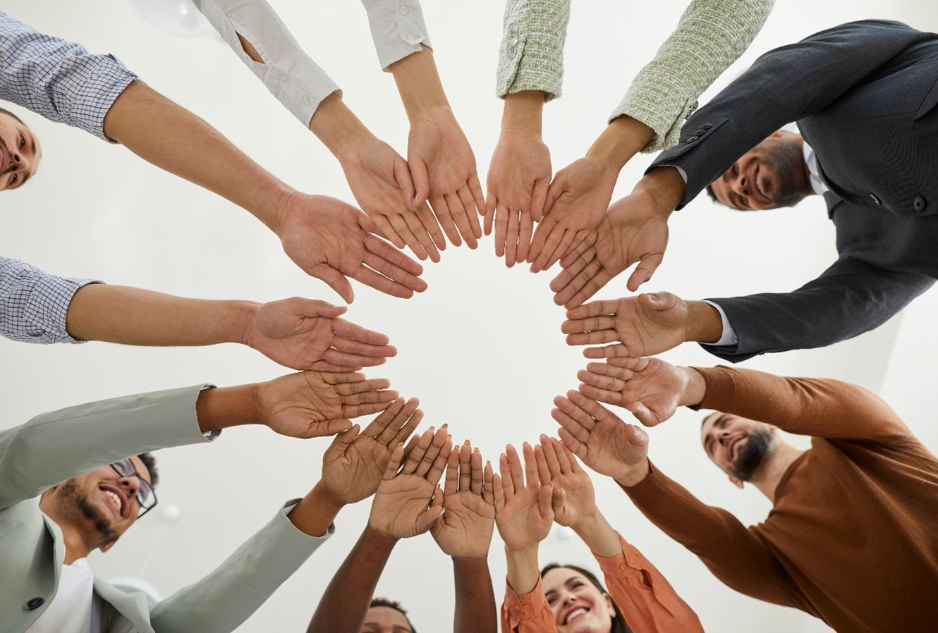 A group of people putting their hands together showing unity