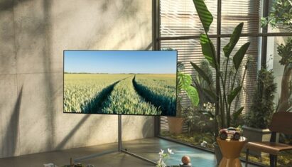 LG OLED TV in the corner of a room with various plants.
