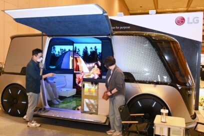 Two visitors taking a look at LG Omnipod displayed at the booth of IEEE International Conference on Communications