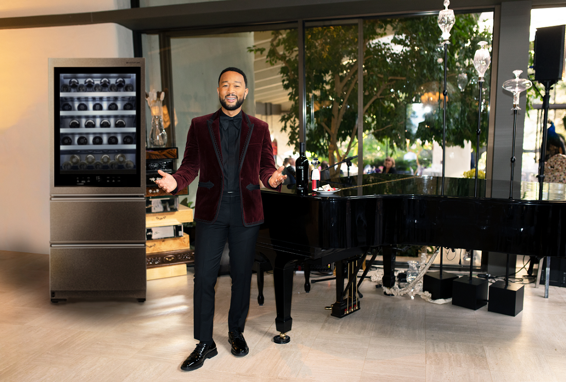 John Legend in suit posing in front of LG Wine Cellar