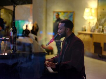 John Legend performing his songs with the piano