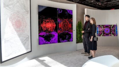 Two visitors viewing Kevin McCoy's work of art displayed on LG OLED TV