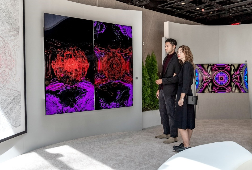 Two visitors viewing Kevin McCoy's work of art displayed on LG OLED TV