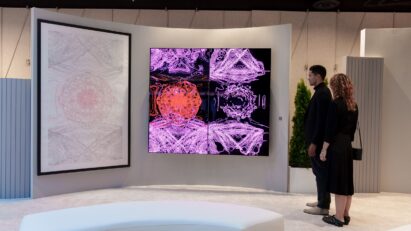 Two visitors viewing Kevin McCoy's work of art displayed on LG OLED TV