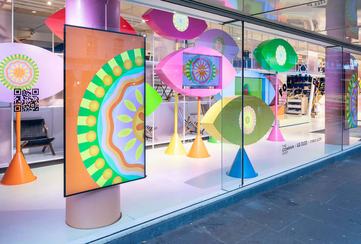 LG OLED evo TVs featured in Yinka Ilori's art installations titled 'Forest of Eyes' in the display window at the Conrad Shop