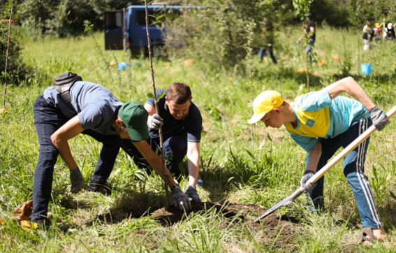 Staff of LG Kazakhstan and children from Almaty Regional Orphanage planting a tree together