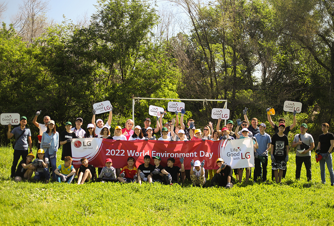 Staff of LG Kazakhstan and children from Almaty Regional Orphanage posing together for a photo after the planting activity