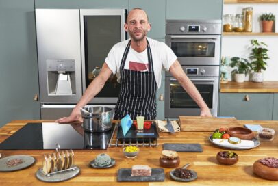 Chris Denny posing in the kitchen prepared to film LG SIGNATURE event