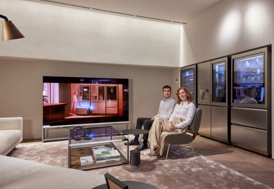 Two visitors posing in front of LG SIGNATURE products displayed during Milan Design Week 2022