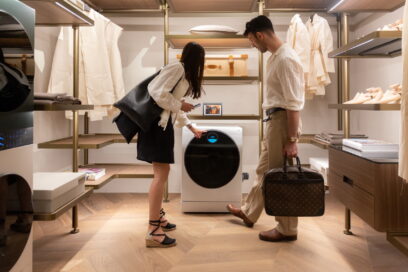 Two visitors taking a closer look at LG washer during Milan Design Week 2022