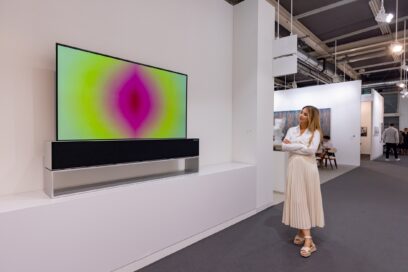 A woman is watching Anish Kapoor’s Media Art with vivid colors beautifully displayed on LG SIGNATURE OLED R in Basel.