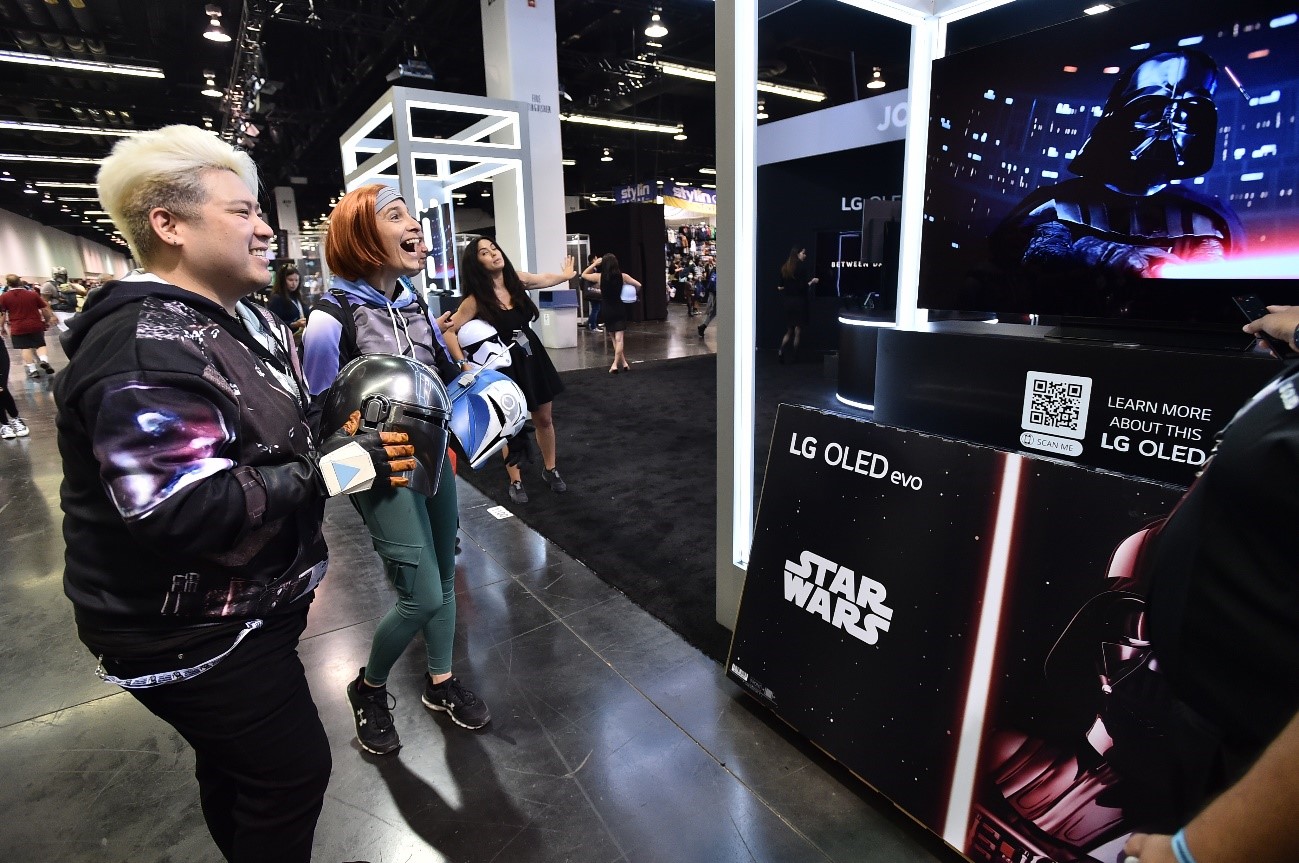 Visitors taking a look at LG OLED TV showcased at the Star Wars celebration in Anaheim, California