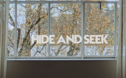 A photo of the window with the phrase 'HIDE AND SEEK' overlapping