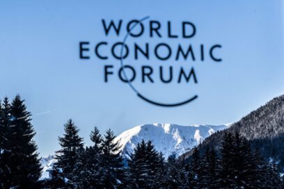 The logo of WEF with a view of Davos, Switzerland in the background.