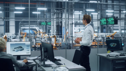 A worker looking over the production process of machines