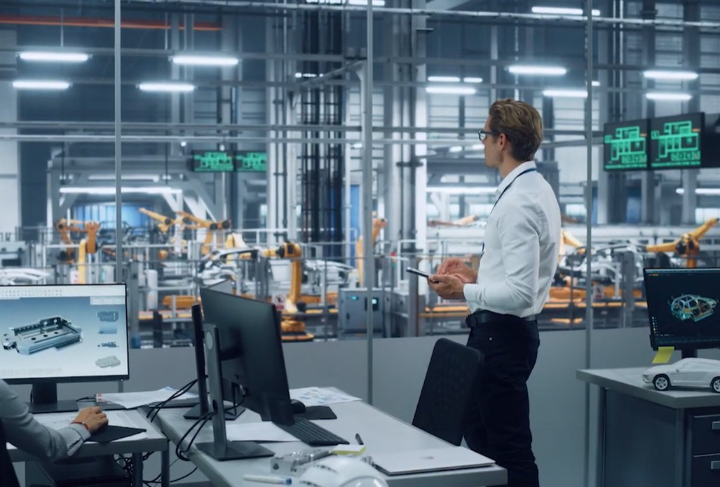 A worker looking over the production process of machines