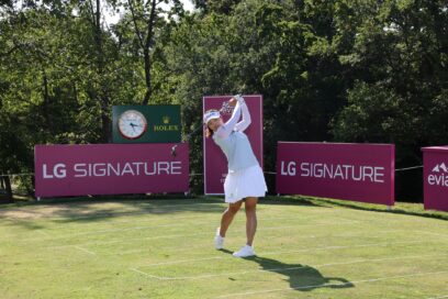 Professional golfer Ko Jin-young tees off in front of LG SIGNATURE signage.