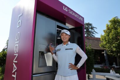 Professional golfer Ko Jin-young posing next to LG SIGNATURE Refrigerator, with a bottle of chilled water in her hand
