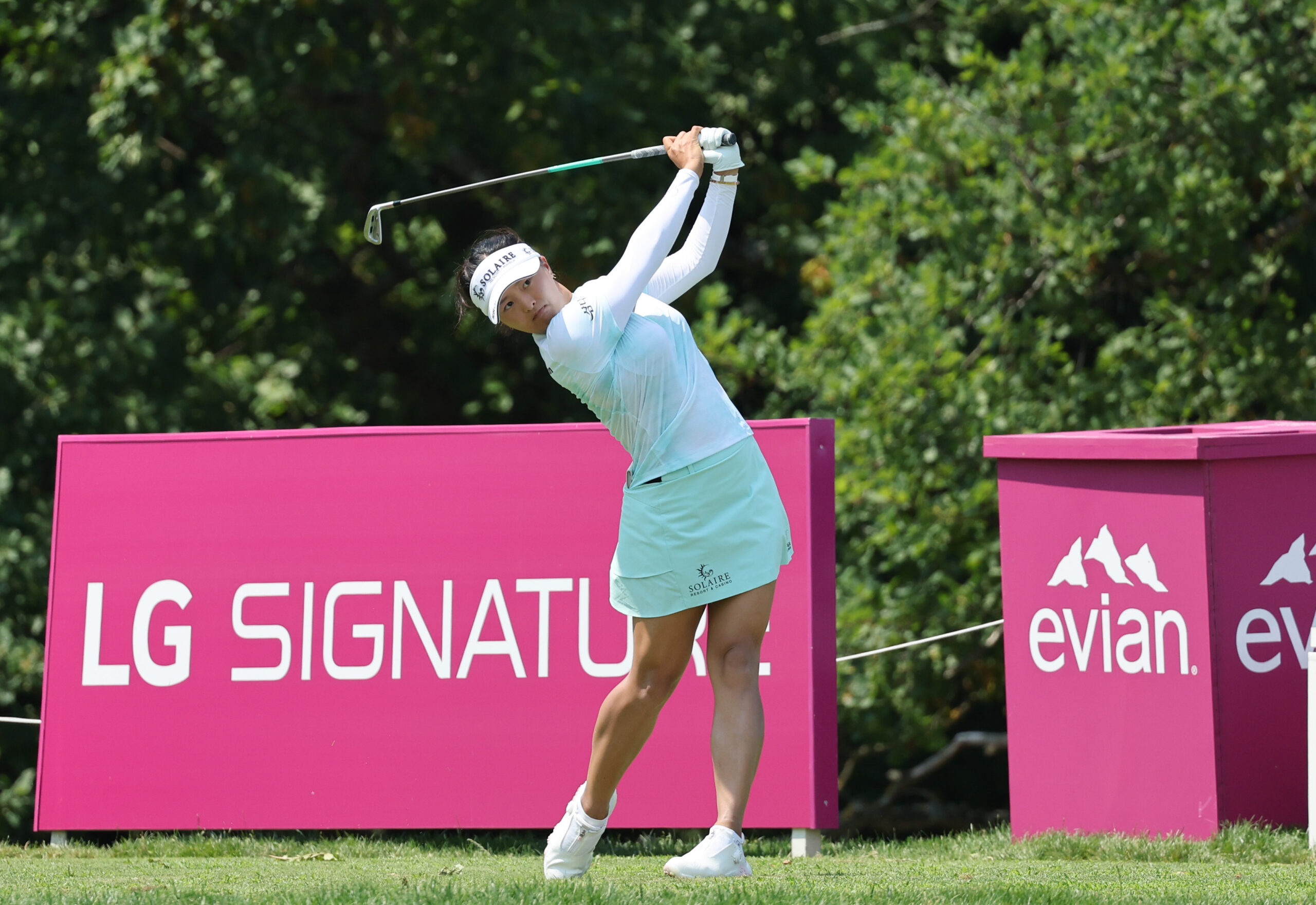 Golfer Ko Jin-young teeing off in front of LG SIGNATURE signage at the Amundi Evian Championship