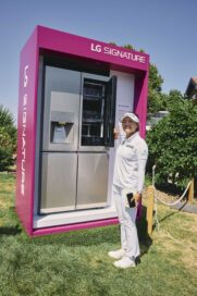Golfer Ko Jin-young posing in front of the LG SIGNATURE InstaView Door-in-Door refrigerator displayed at the Amundi Evian Championship