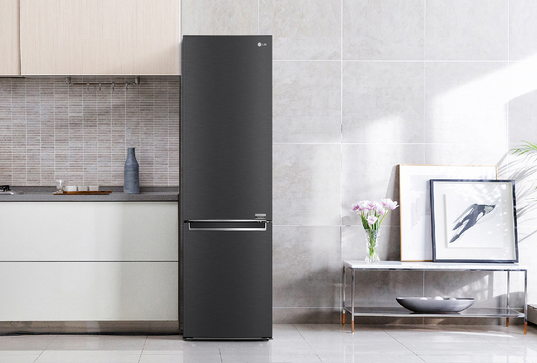 LG's new bottom freezer with top-tier energy efficiency is placed next to the kitchen drawers