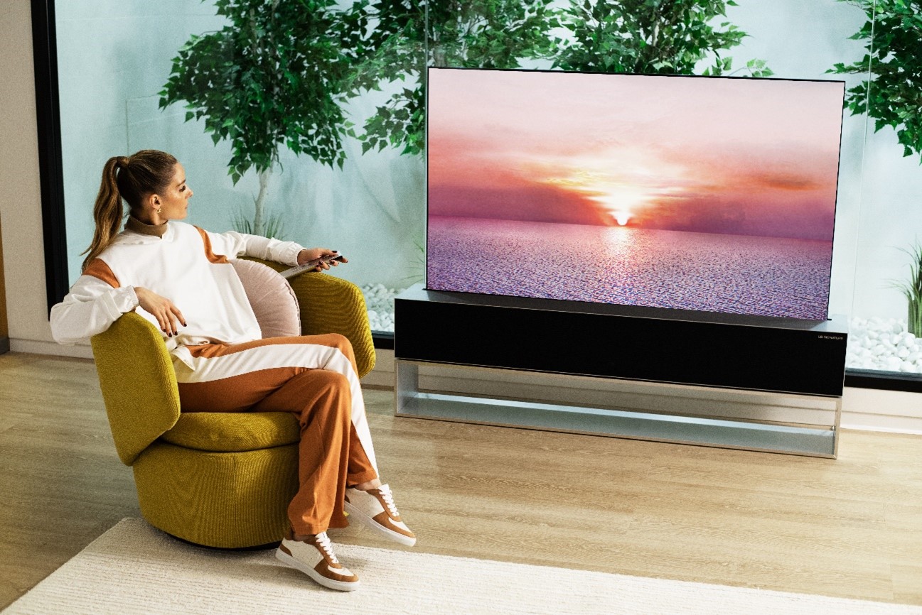 Olivia Palermo is watching the LG SIGNATURE OLED R TV, positioned in the living room.