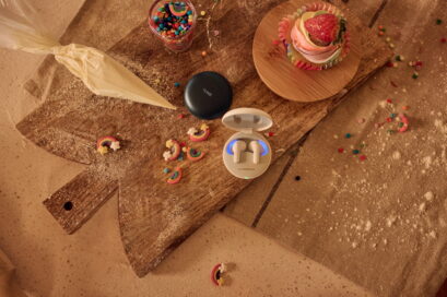 The black and white models of LG TONE Free T90 surrounded by colorful desserts on a kitchen table