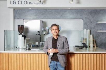Lee Sam-soo, Chief Digital Officer at LG Electronics, posing in front of LG CLOi BaristaBot