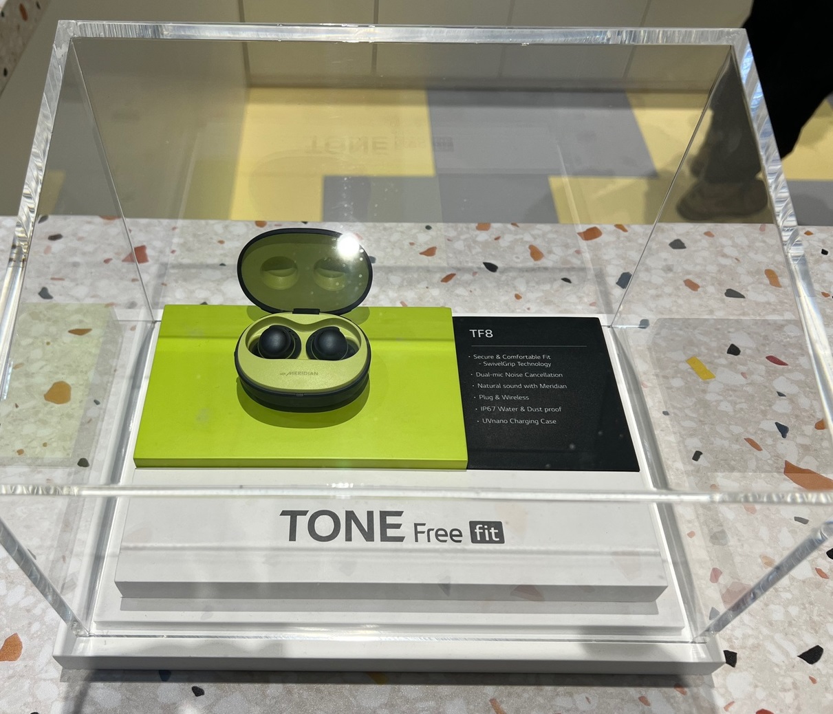 The TONE Free fit displayed under glass at LG's booth at IFA 2022.