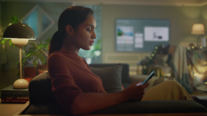 A woman using her phone in the living room