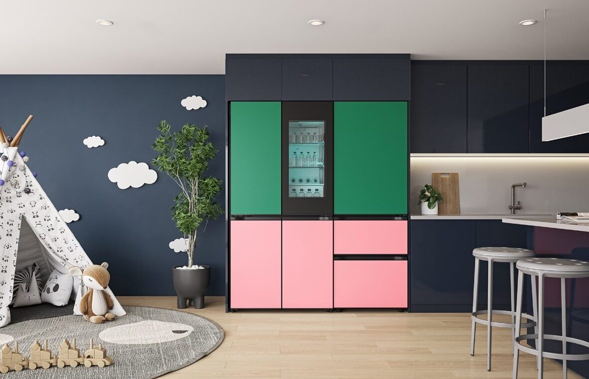 The LG MoodUP refrigerator, with green panels on top and pink panels on the bottom, pictured in a home.