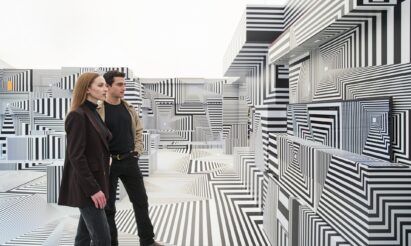 Two visitors taking a closer look at LG OLED-powered “Into the Maze” installation by the German artist, Tobias Rehberger