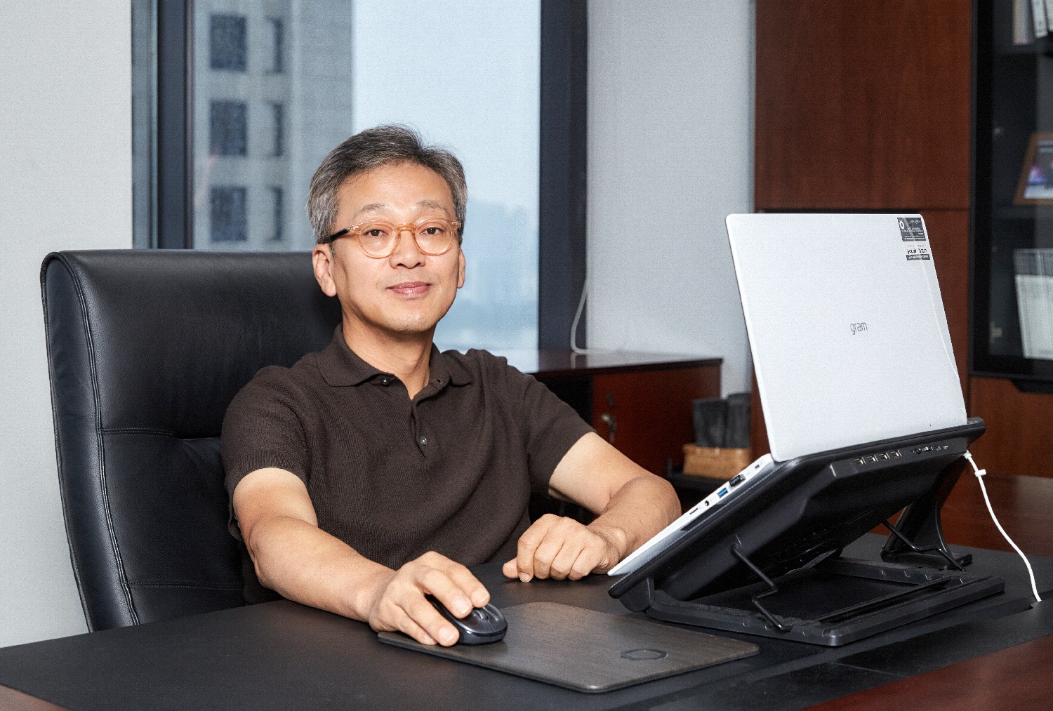 Lee Sam-soo, Chief Digital Officer at LG Electronics, posing at his office with LG gram