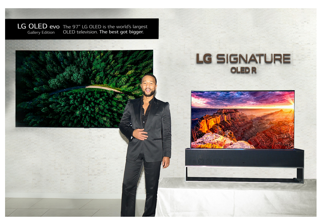 Singer John Legend posing in front of LG 97-inch G2 OLED evo TV and LG SIGNATURE OLED R TV at CEDIA Expo 2022