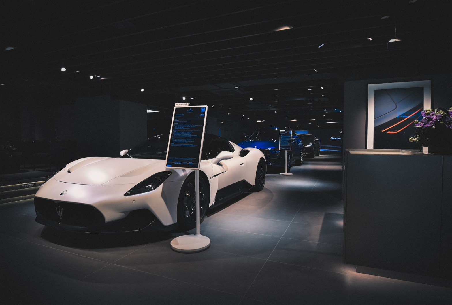 LG StanbyME installed next to the Maserati's luxurious automobile at Maserati showroom in Hong Kong