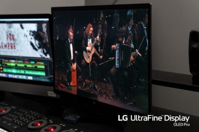 A closeup photo of LG UltraFine Display OLED Pro monitor displaying an orchestra during its performance