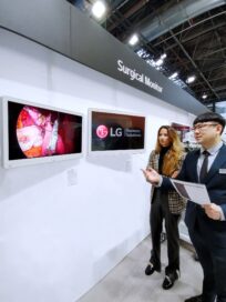 LG booth in MEDICA – A staff explains features of LG medical monitors to a visitor