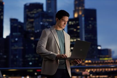 A man using LG gram with the city night view in the background