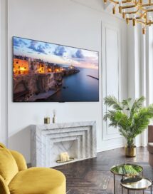 A 2023 LG OLED TV mounted on the wall of a bright, modern living room