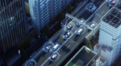 Image of many cars on the road located in the city full of buildings