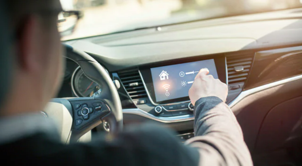 Man touching a screen of the infotainment on his vehicle