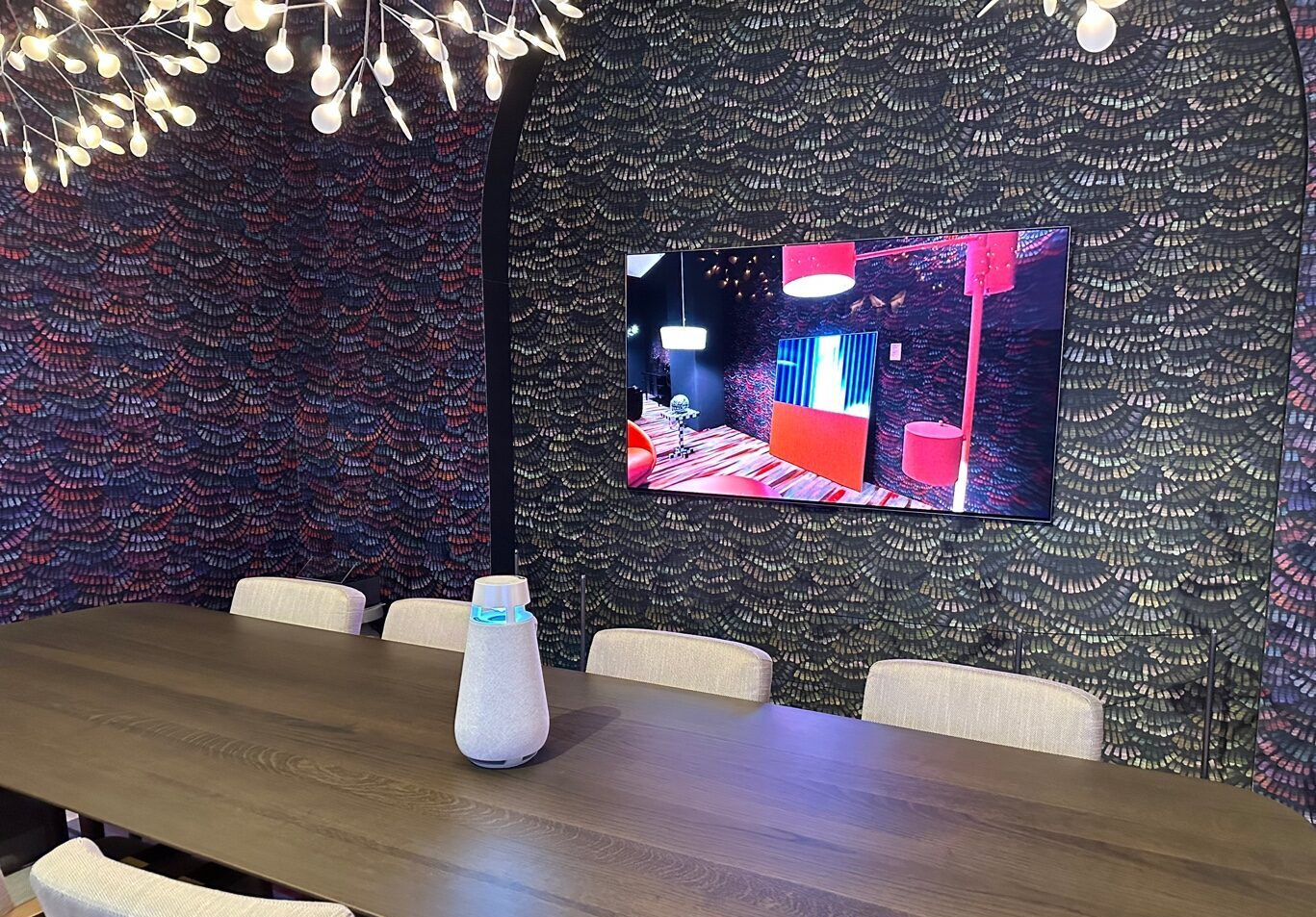 The 2023 LG Lifestyle screen mounted on the wall of a CES 2023 showroom with LG XBOOM speaker on the table in front