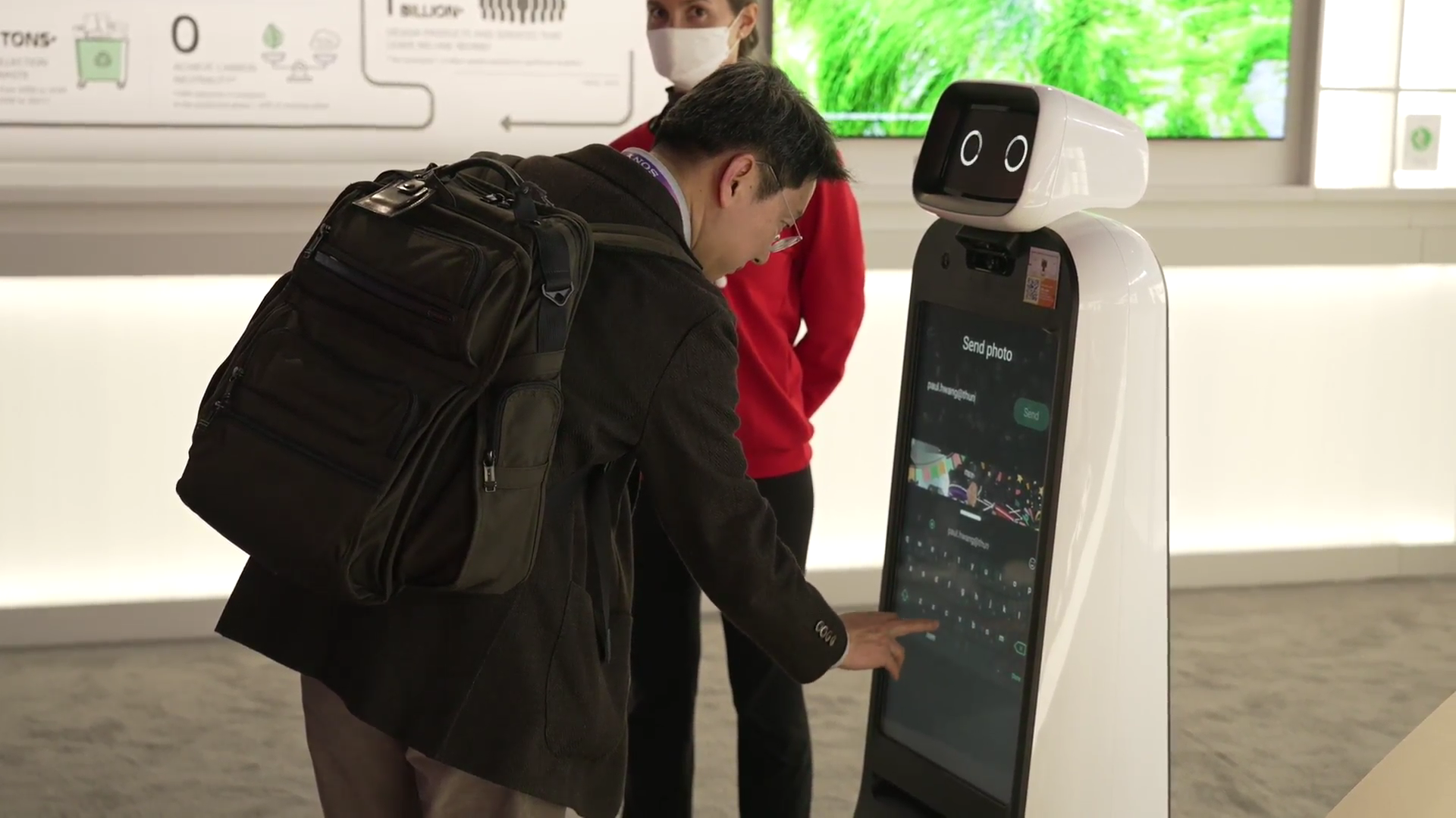 A visitor at LG Booth getting some help from LG CLOi GuideBot