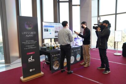 Day1Lab’s booth at the LIFE’S GOOD AWARD Conference, with a representative discussing the solution with a camera crew.