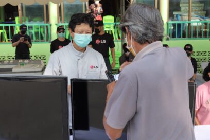 LG technician providing an inspection and maintenance service to flood-damaged appliances